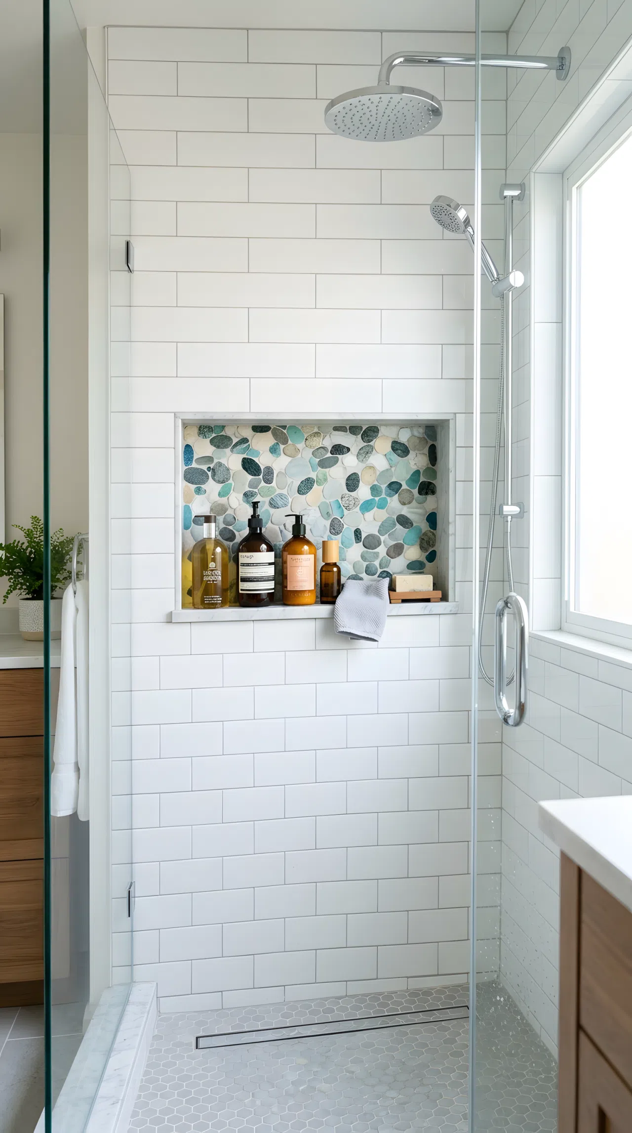 Real-life photo of a tiled shower with a recessed niche shelf holding neatly arranged bottles, contrasting accent stone lining, bright natural light, clean and beautifully organized, vibrant fresh tones, stock photography style.