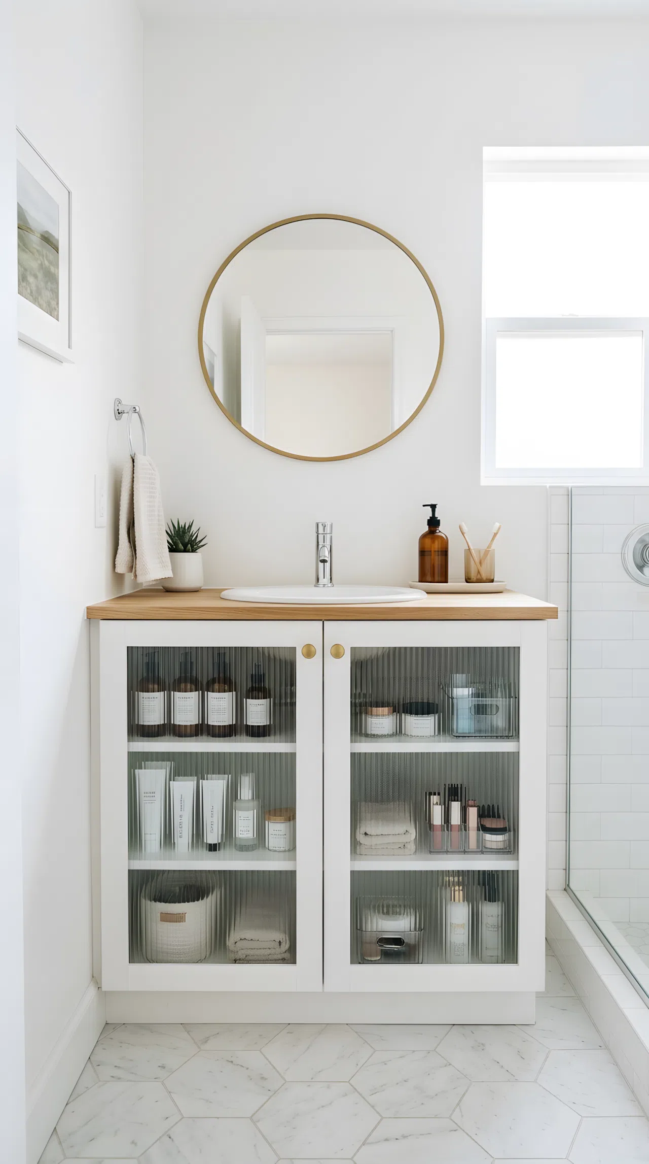 Real-life photo of a small hallway bathroom vanity with fluted glass cabinet doors, neatly organized toiletries subtly visible through the ribbed glass, white walls, bright natural light, beautifully arranged, organized, clean, vibrant soft tones, stock photography style.