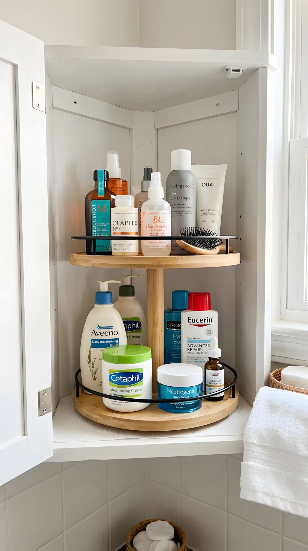 Inside a bathroom corner cabinet, a two-tier lazy Susan neatly holding lotion bottles and hair products, organized, clean, beautifully arranged, bright natural light, real-life photography, vibrant colors.
